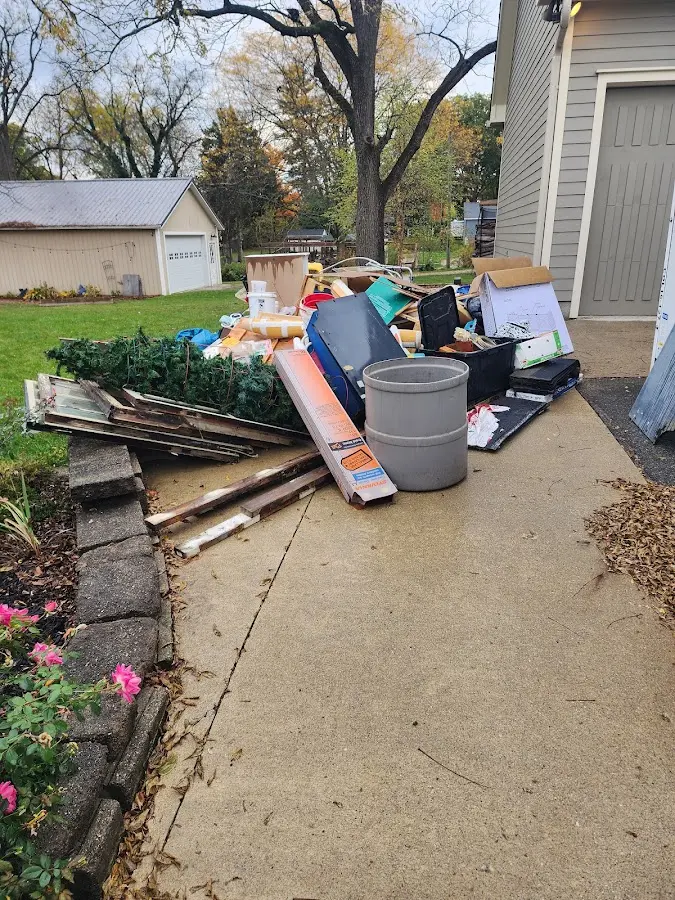 Dumpster being loaded with debris for Estate Cleanout Dumpster Rental in Durango